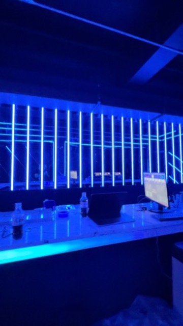 Blue lighting across the mirrored back bar and counter at Anthem Orlando