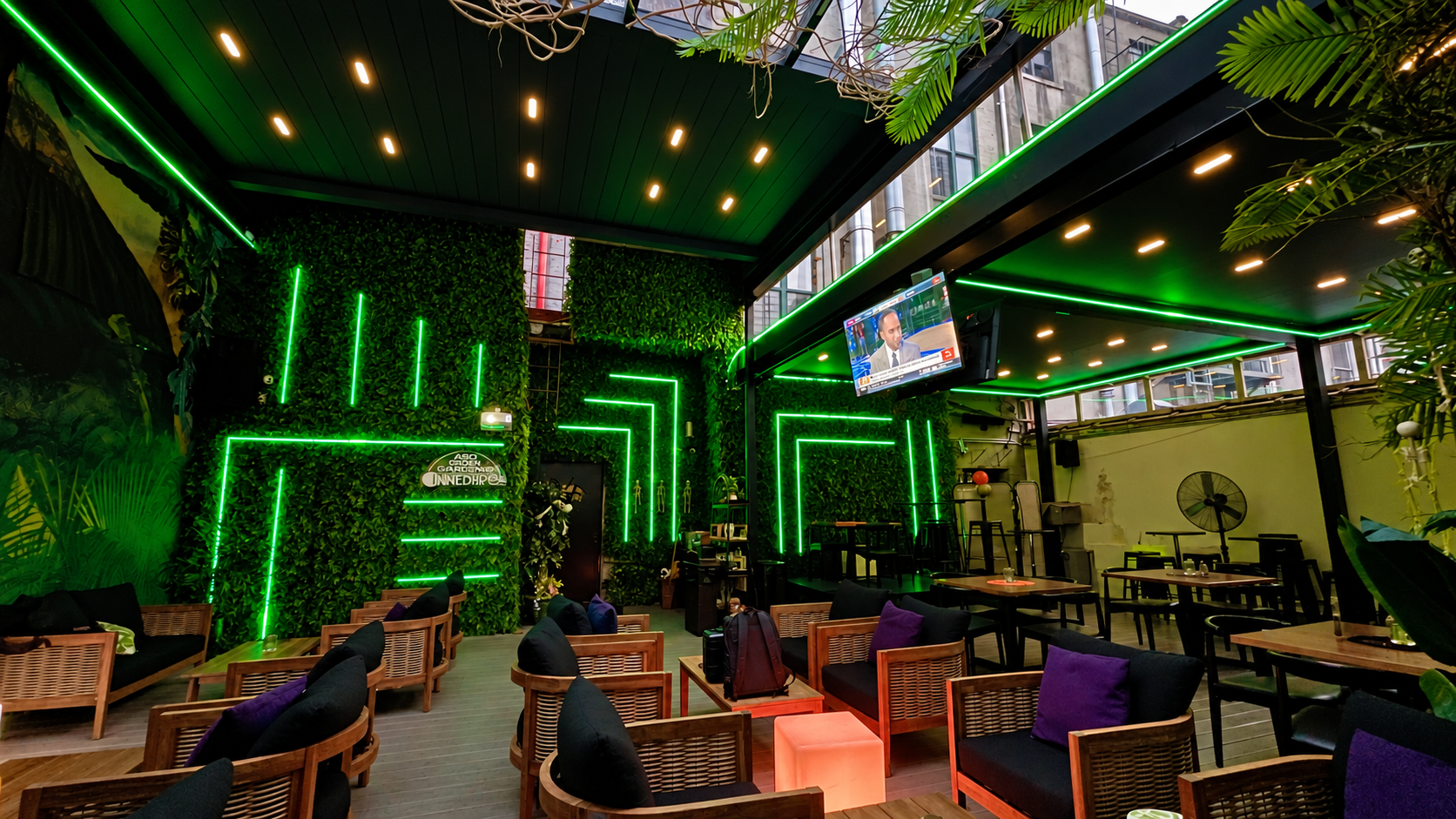 Green linear lighting across the walls and ceiling at iNine Bistro in Bronx, New York