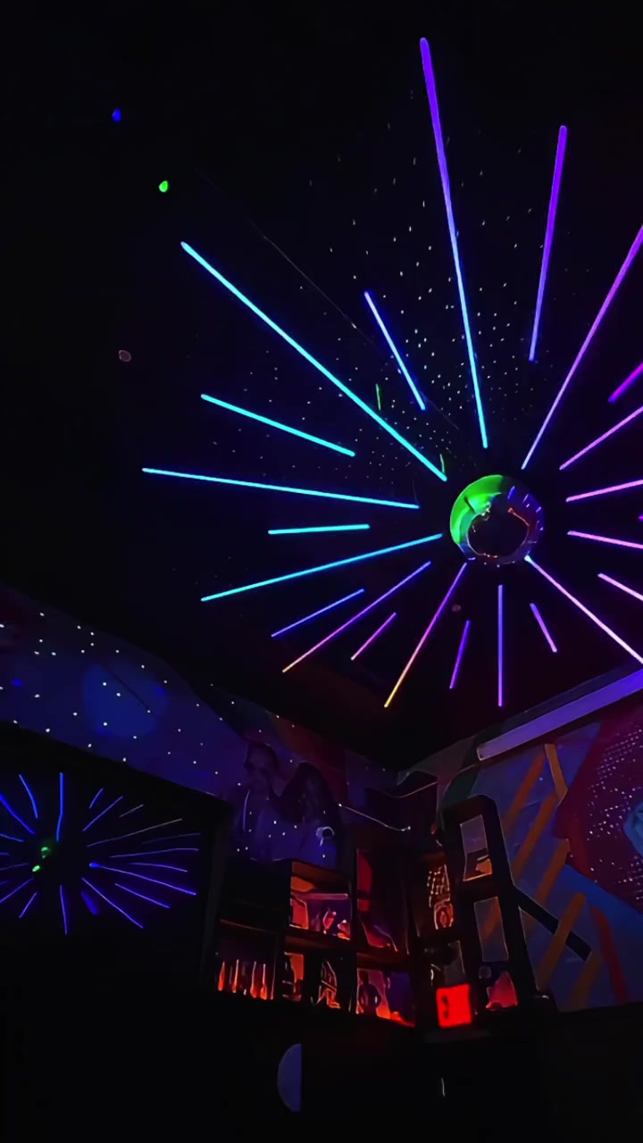 Colorful radial ceiling lights surrounding a mirror ball at Disco Sallys in NYC