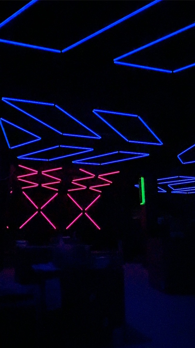 Blue ceiling outlines and pink geometric wall lighting at Havoc