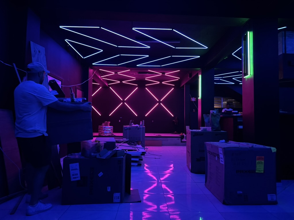 Havoc during installation with geometric lighting reflected on the tiled floor