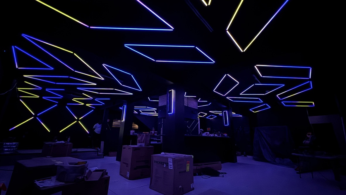 Blue and yellow geometric ceiling lighting across Havoc during installation