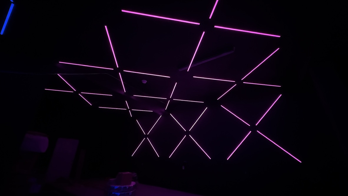 Pink linear fixtures extending across the ceiling and back wall at Havoc